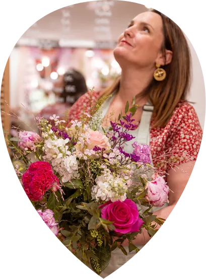 Charlène, artisan fleuriste, tenant un bouquet coloré